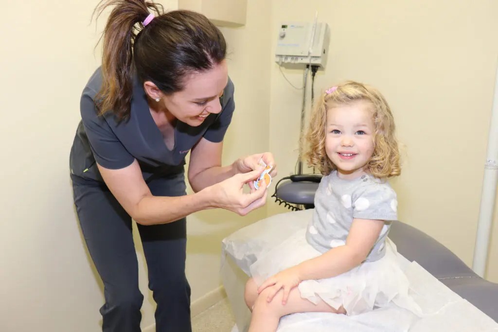 Pediatric dermatologist with a pediatric patient.