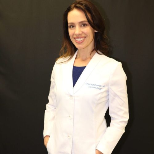 Dr. Kristina Derrick posing for a staff picture. Dr. Derrick is a Pediatric, Cosmetic and Medical Dermatologist.